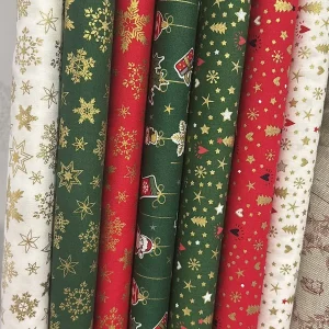 Popelín navideño con motivos dorados